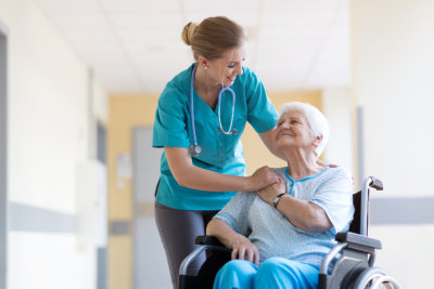 Senior women in wheelchair with female nurse in hospital