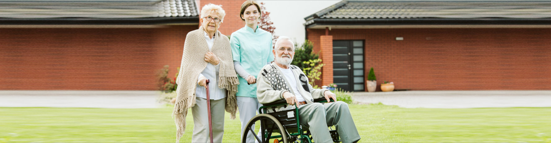 caregiver with two elderly people